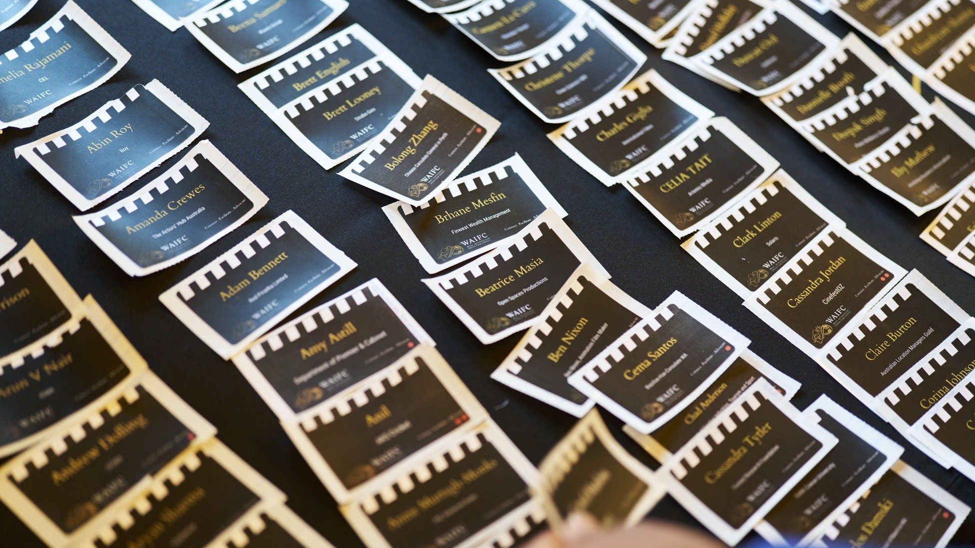 Guest name badges designed as film strips laid out on a table