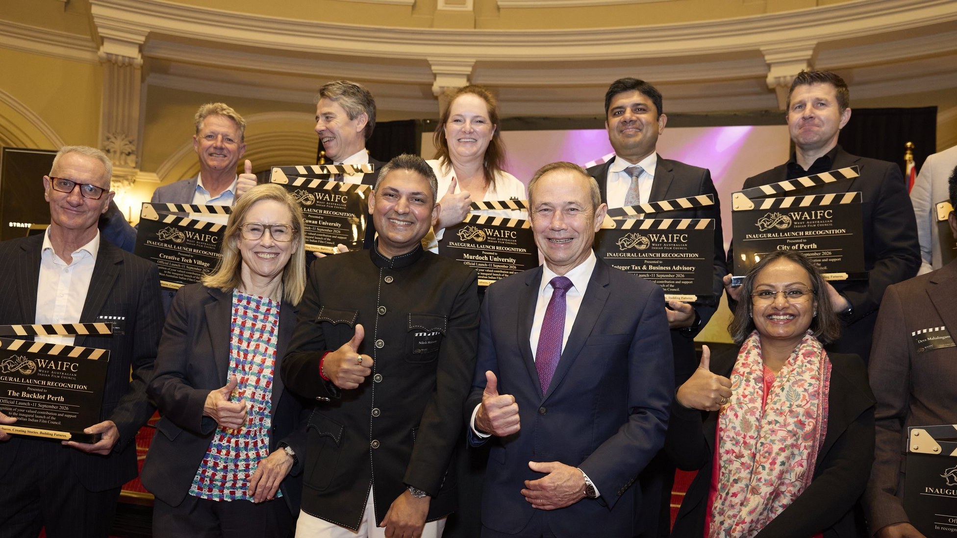 The Premier, the Minister, the Consul General and Nilesh Makwana with partners holding WAIFC clapperboards