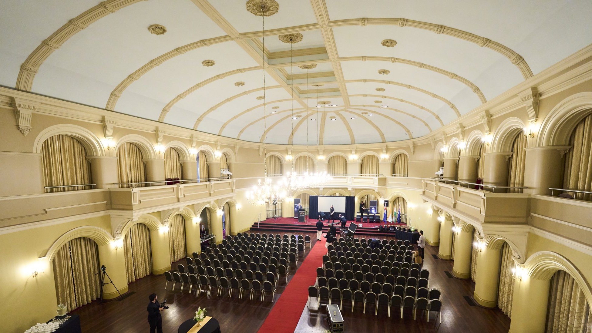The Government House Ballroom in Perth set up with rows of empty chairs and a red carpet aisle before the WAIFC launch
