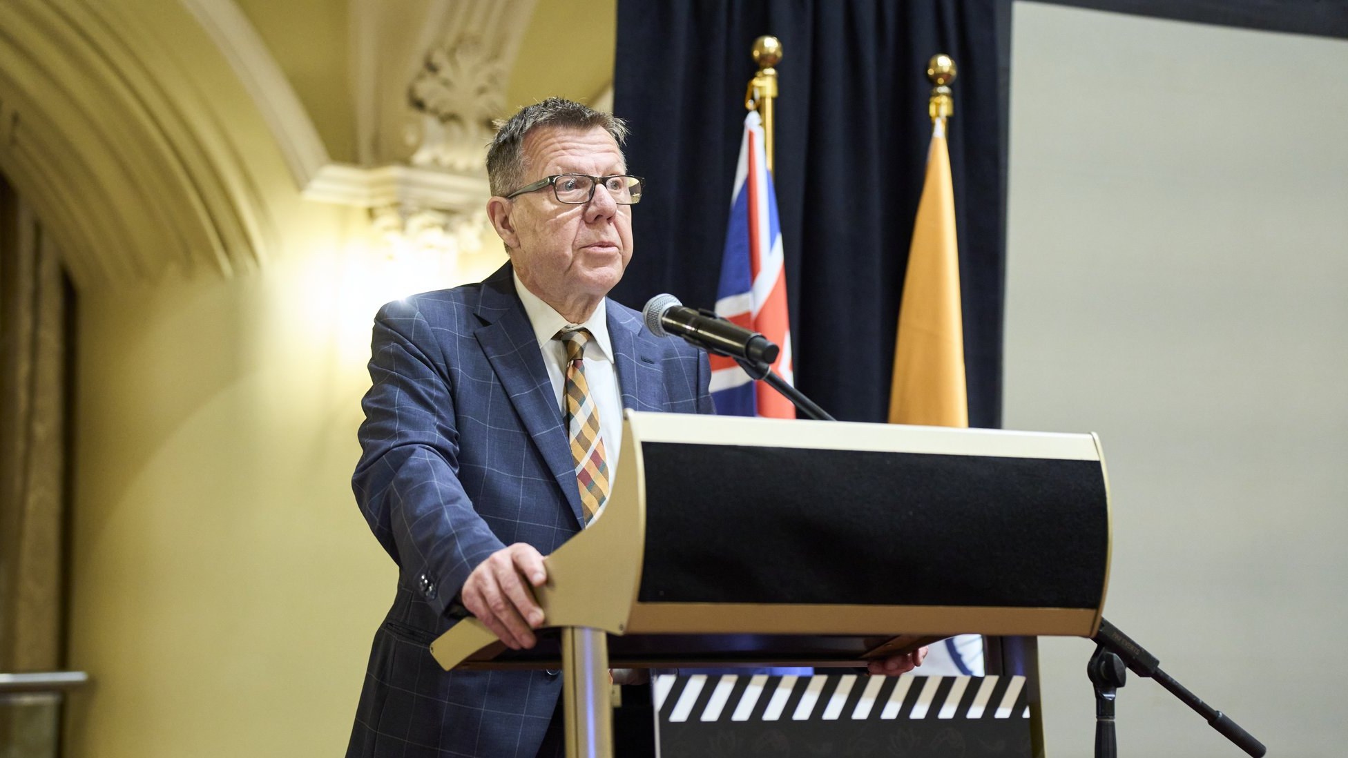 Michael Carter speaking at the WAIFC lectern during the launch at Government House, Perth