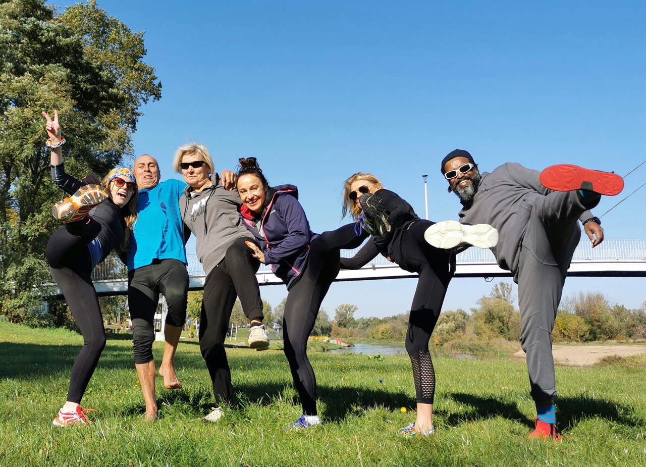 Community fitness participants smiling together during a wellness program event