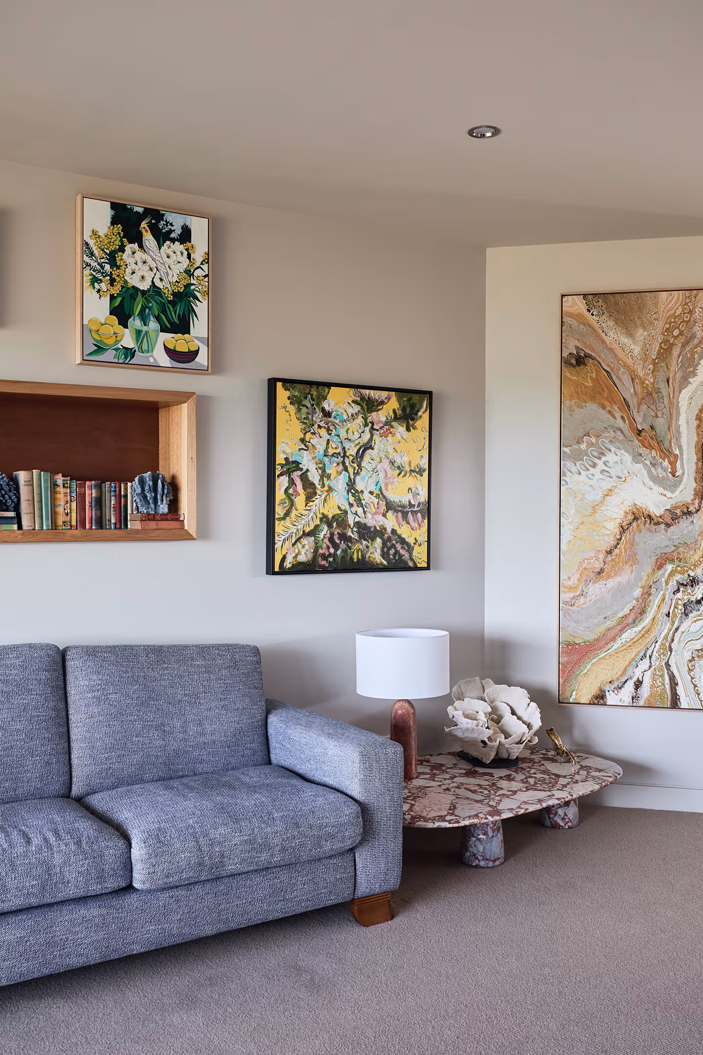 The sofa surrounded by artwork in the living room