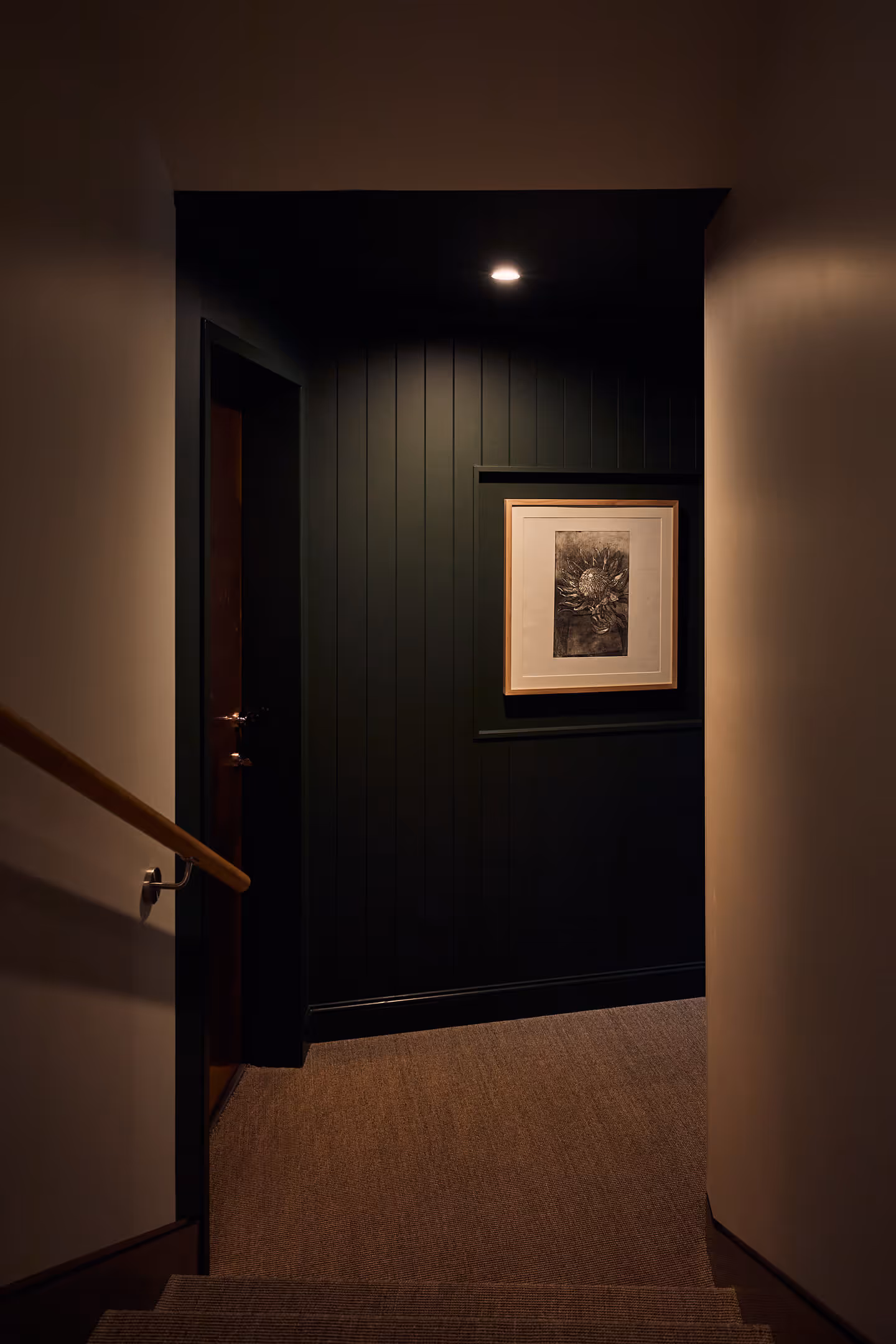 A view down the stairs looking at some artwork on the wall