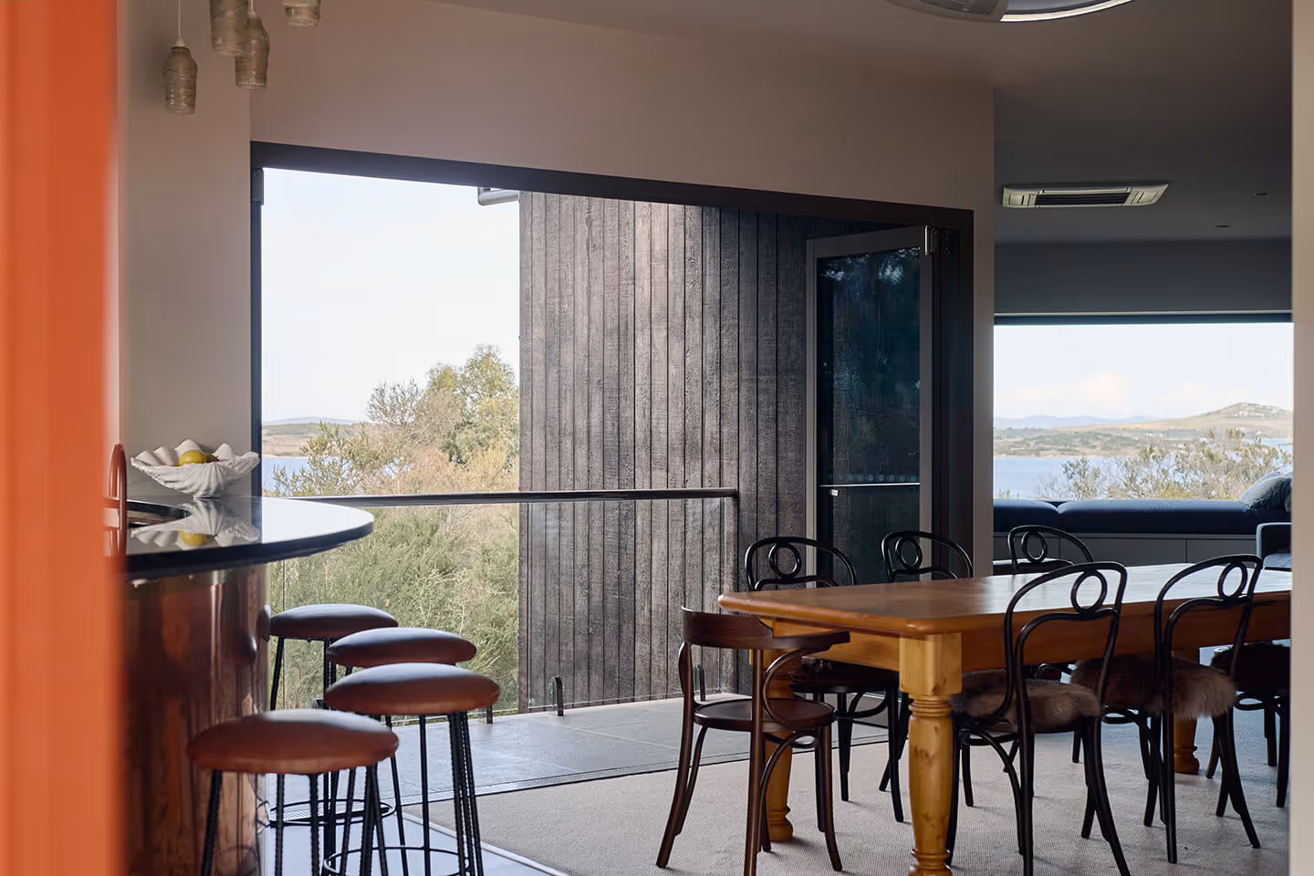 Connected kitchen and dining overlooking the water