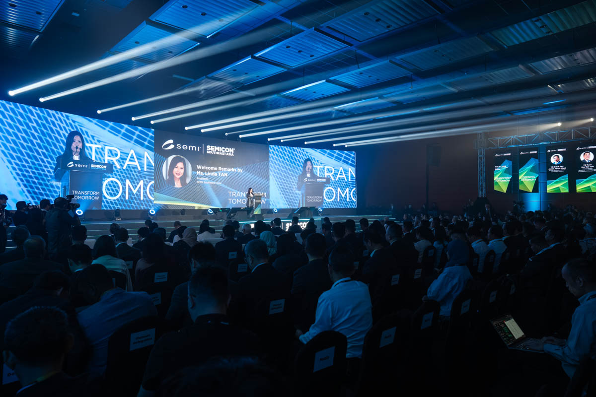 Large audience seated facing stage with speaker and large screens at SEMICON Southeast Asia event.