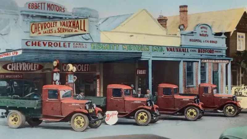 Ebbett Motors 1928 with staff and vintage trucks