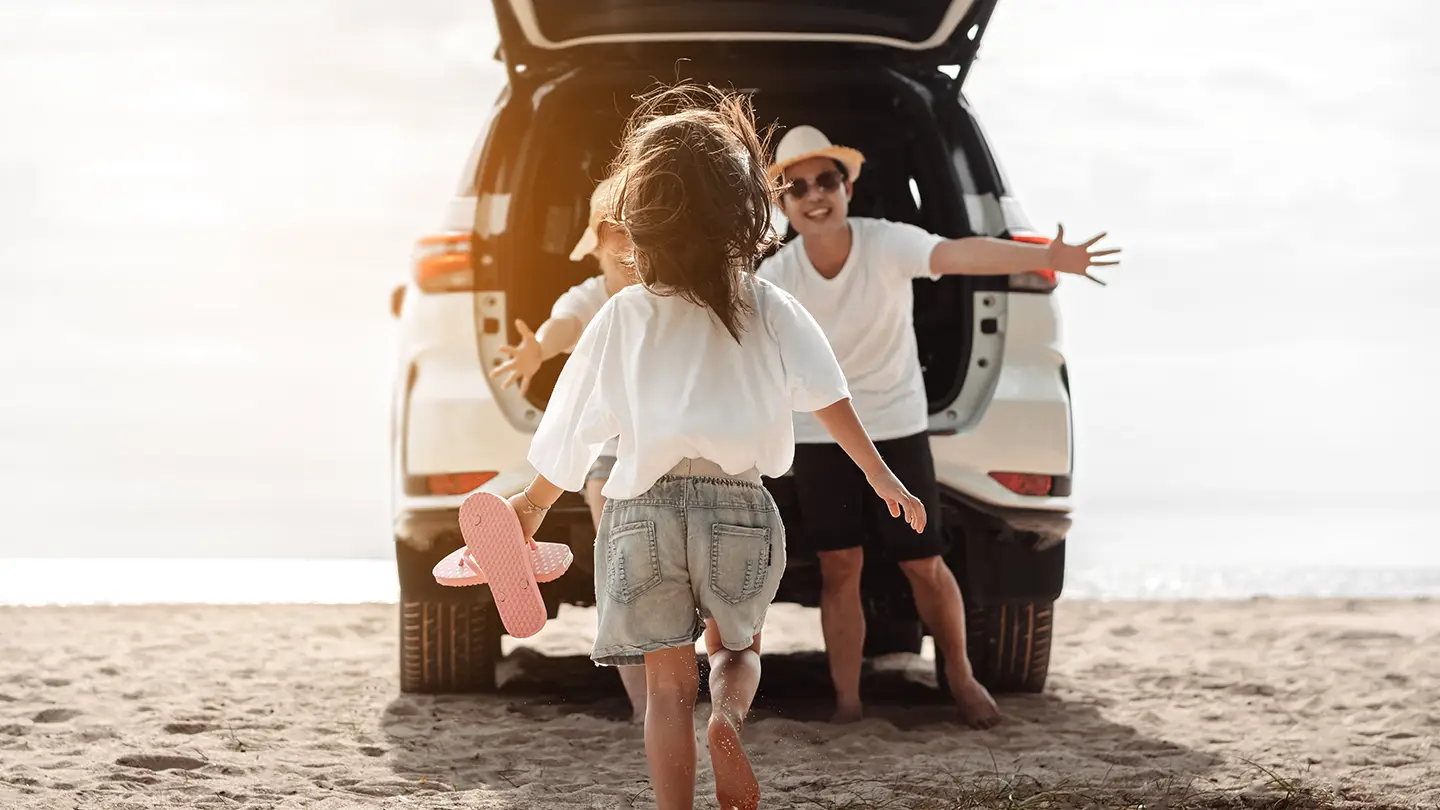 Motor Vehicle Insurance - girl running towards family vehicle