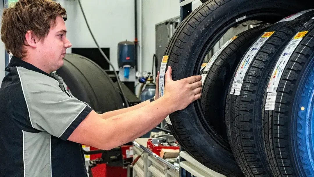 Serviceperson selecting a Tyre for Alignment