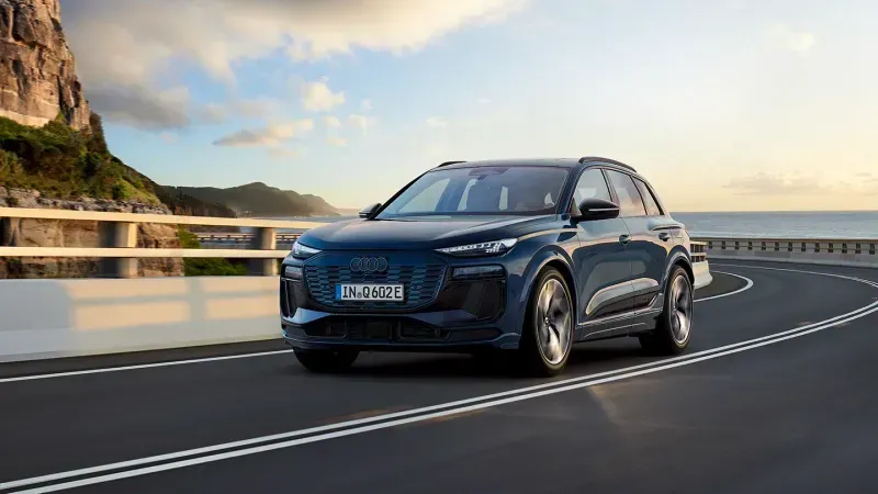 Audi Q6 e-tron front quarter on road by ocean