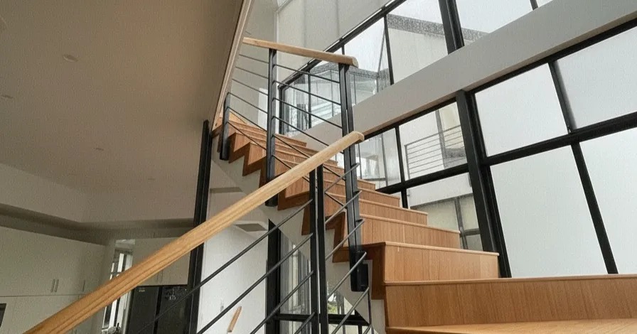 Architectural staircase and double-height glazing in a Sydney renovation