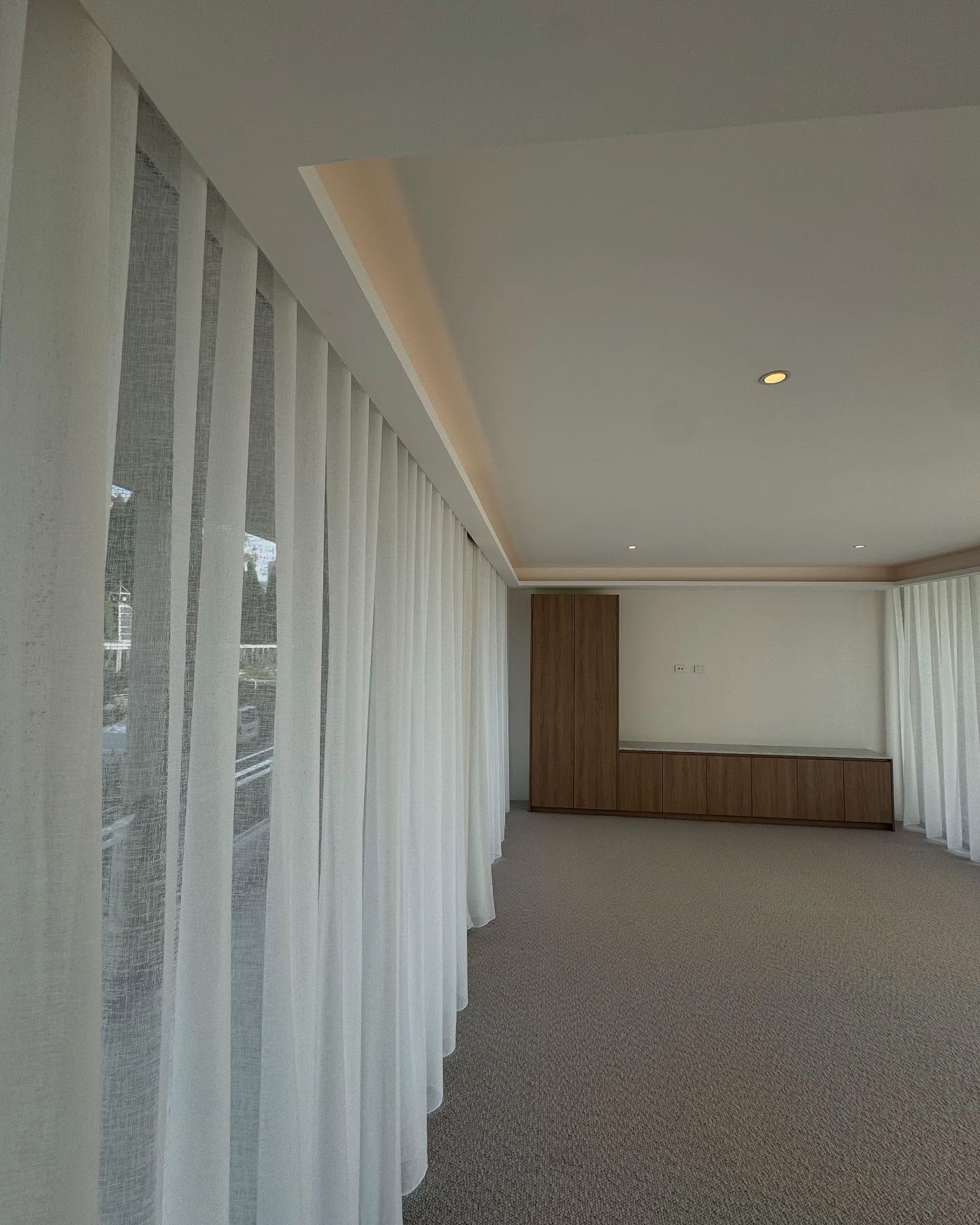 Full-height window treatments and built-in joinery.