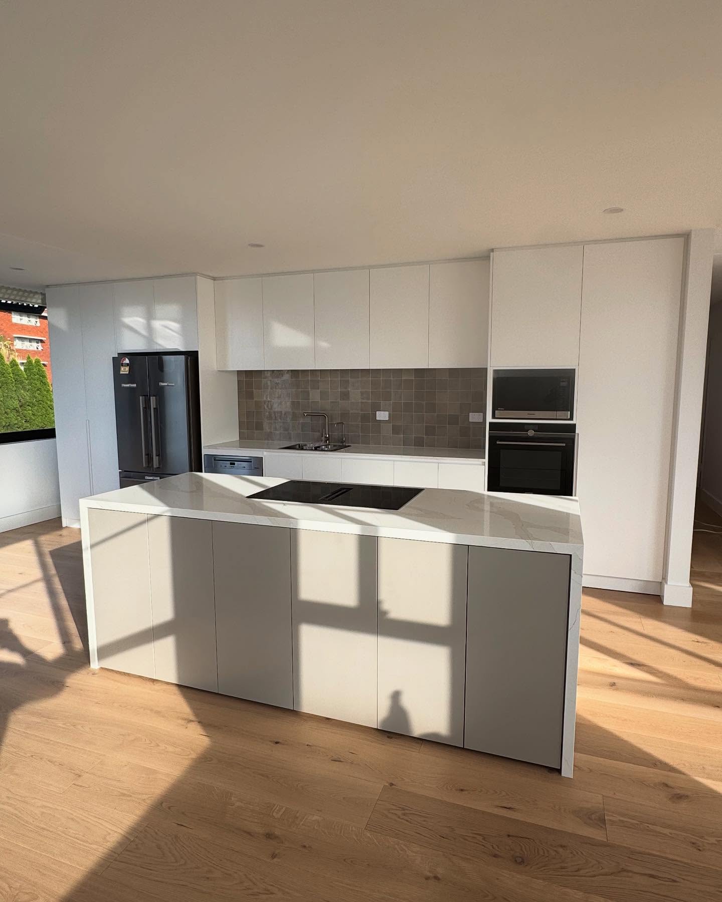 New island joinery and full-height kitchen cabinetry.