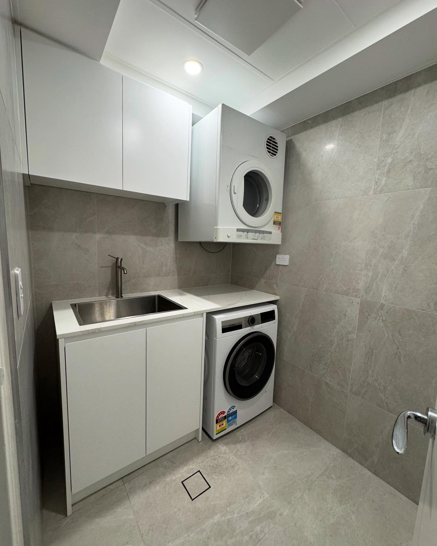 Dedicated laundry with integrated cabinetry.