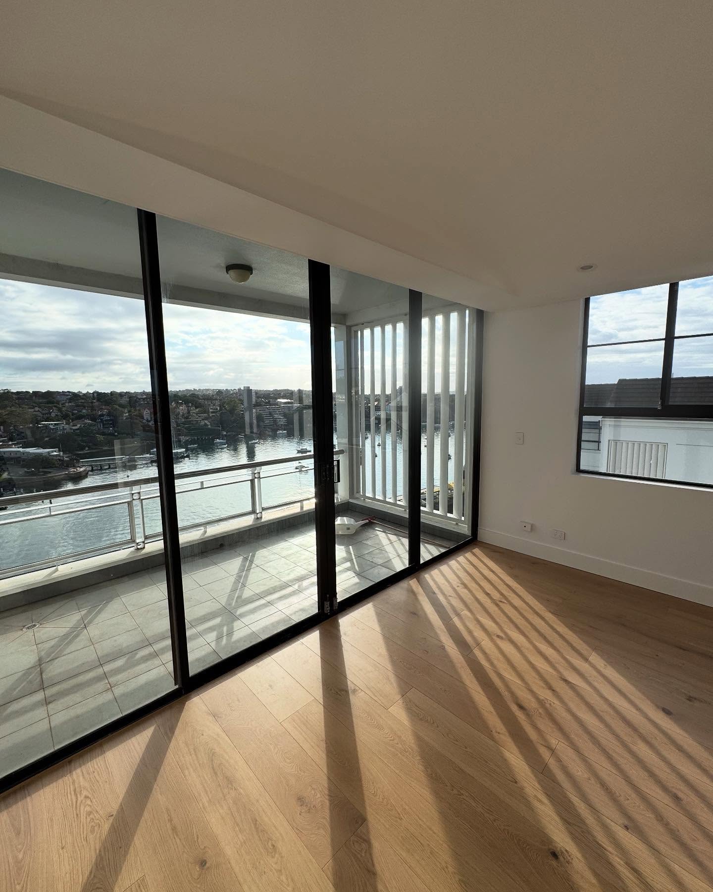 Renewed timber flooring and full-height glazing.
