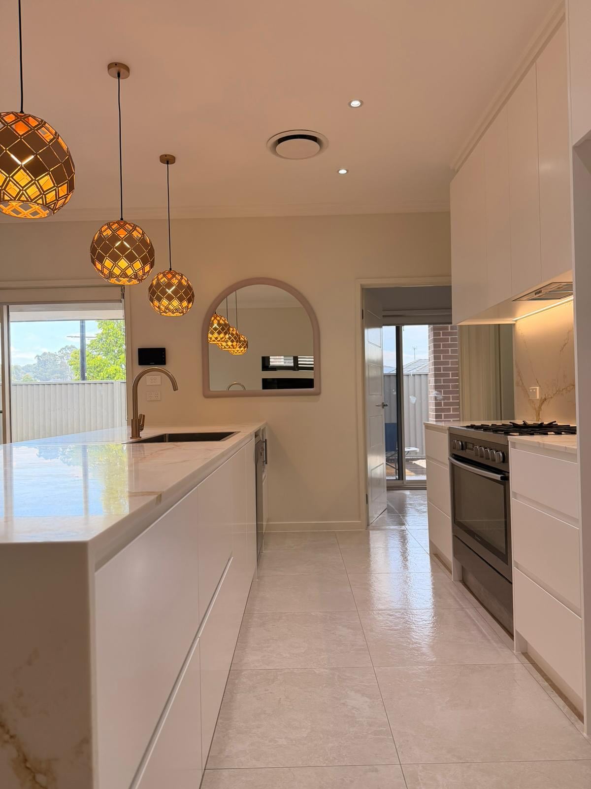 The new kitchen's central work zone and surrounding cabinetry.