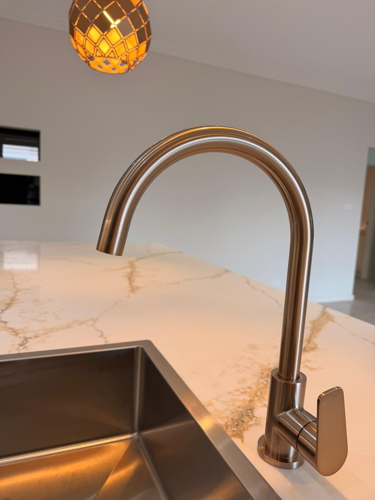 Sink, tapware and stone-benchtop detailing.