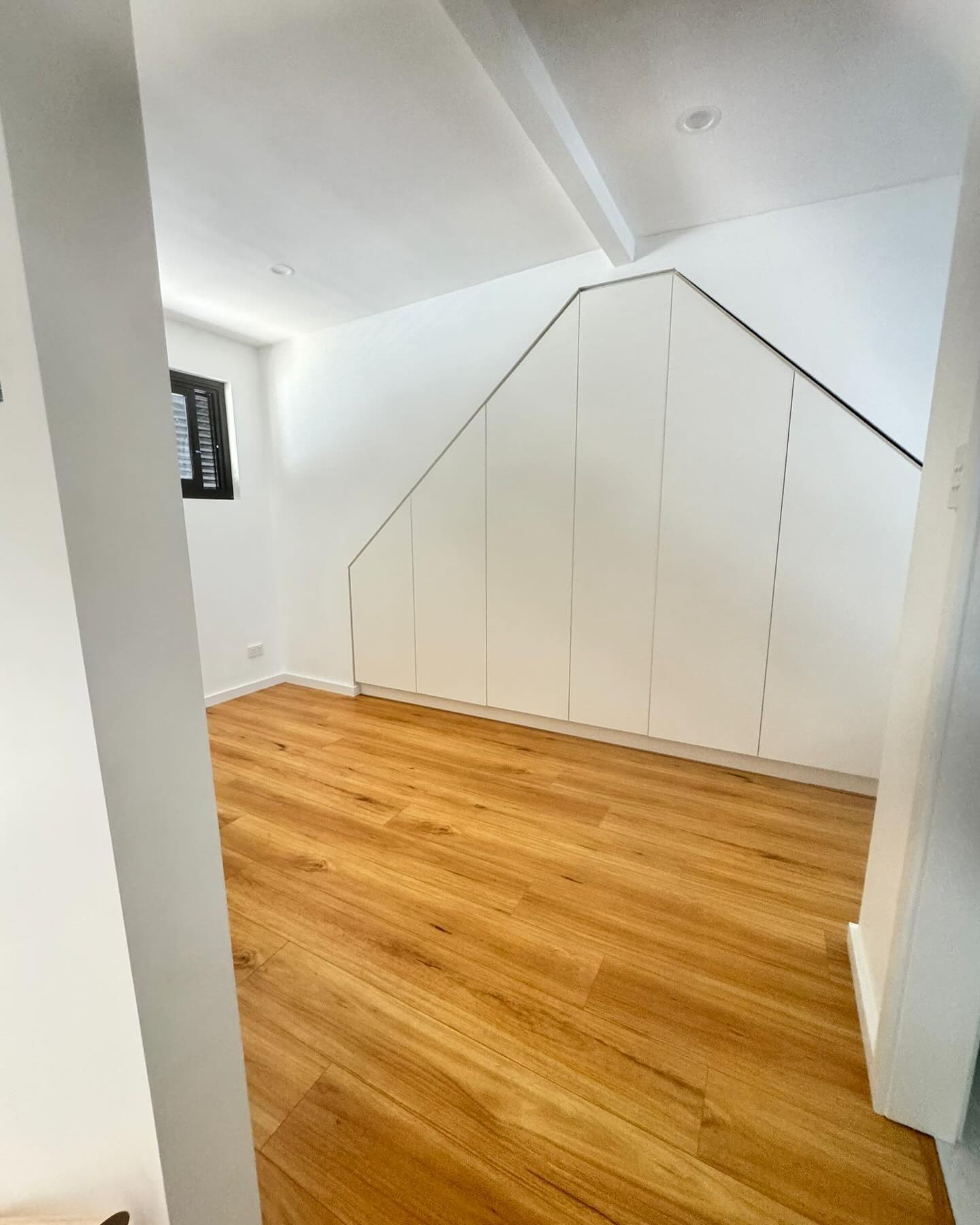 Timber flooring and built-in storage in the upper studio.