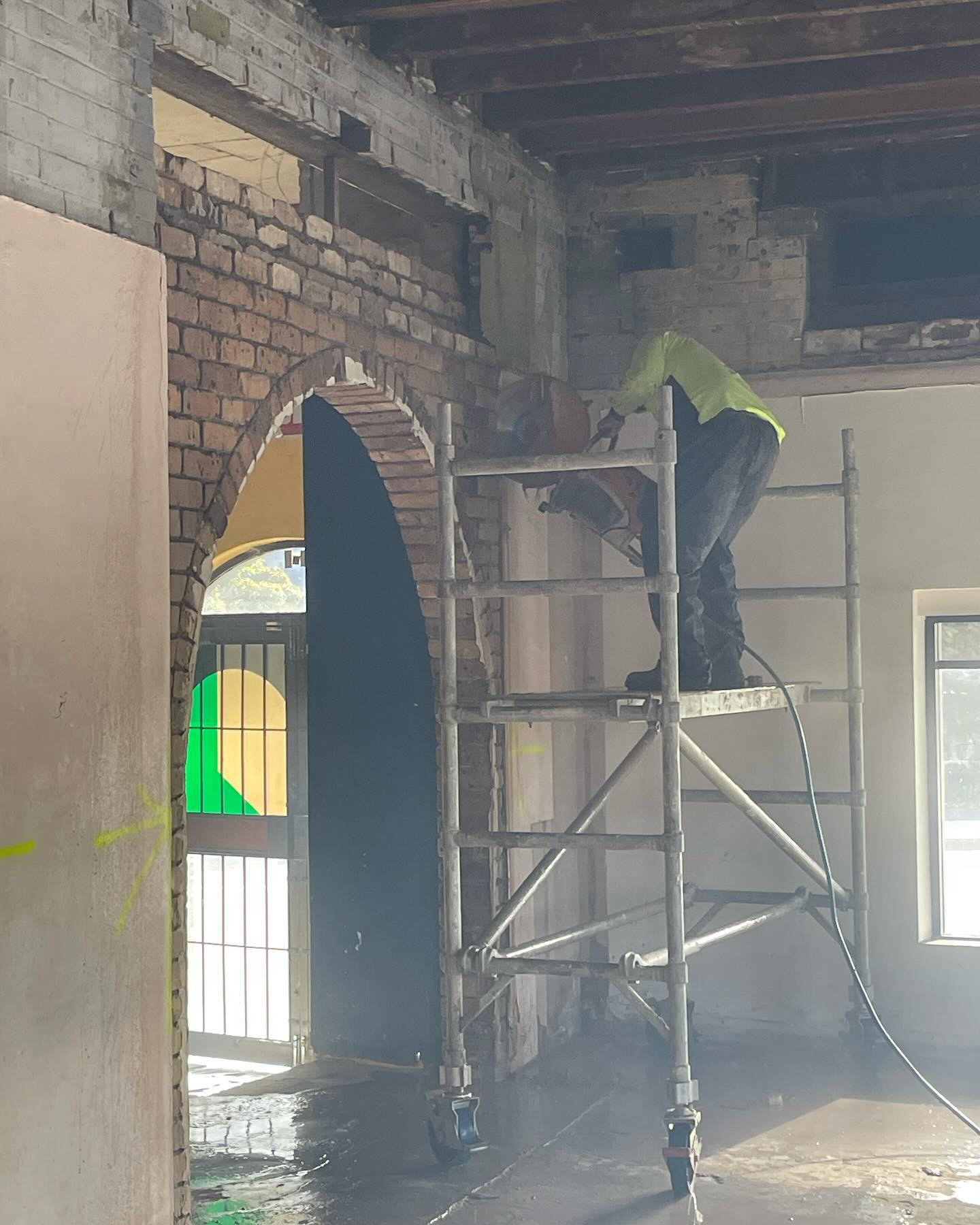 Controlled masonry demolition in progress.