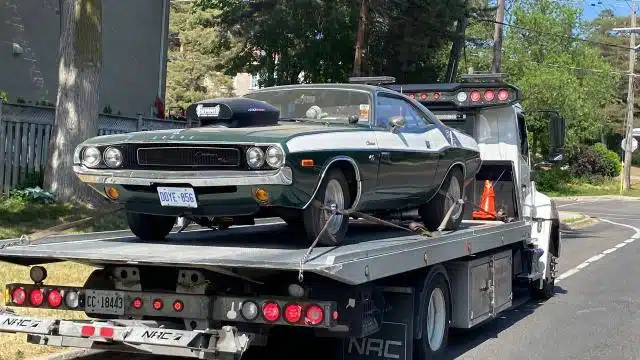 Vintage Dodge Challenger secured on a Norman Towing flatbed.