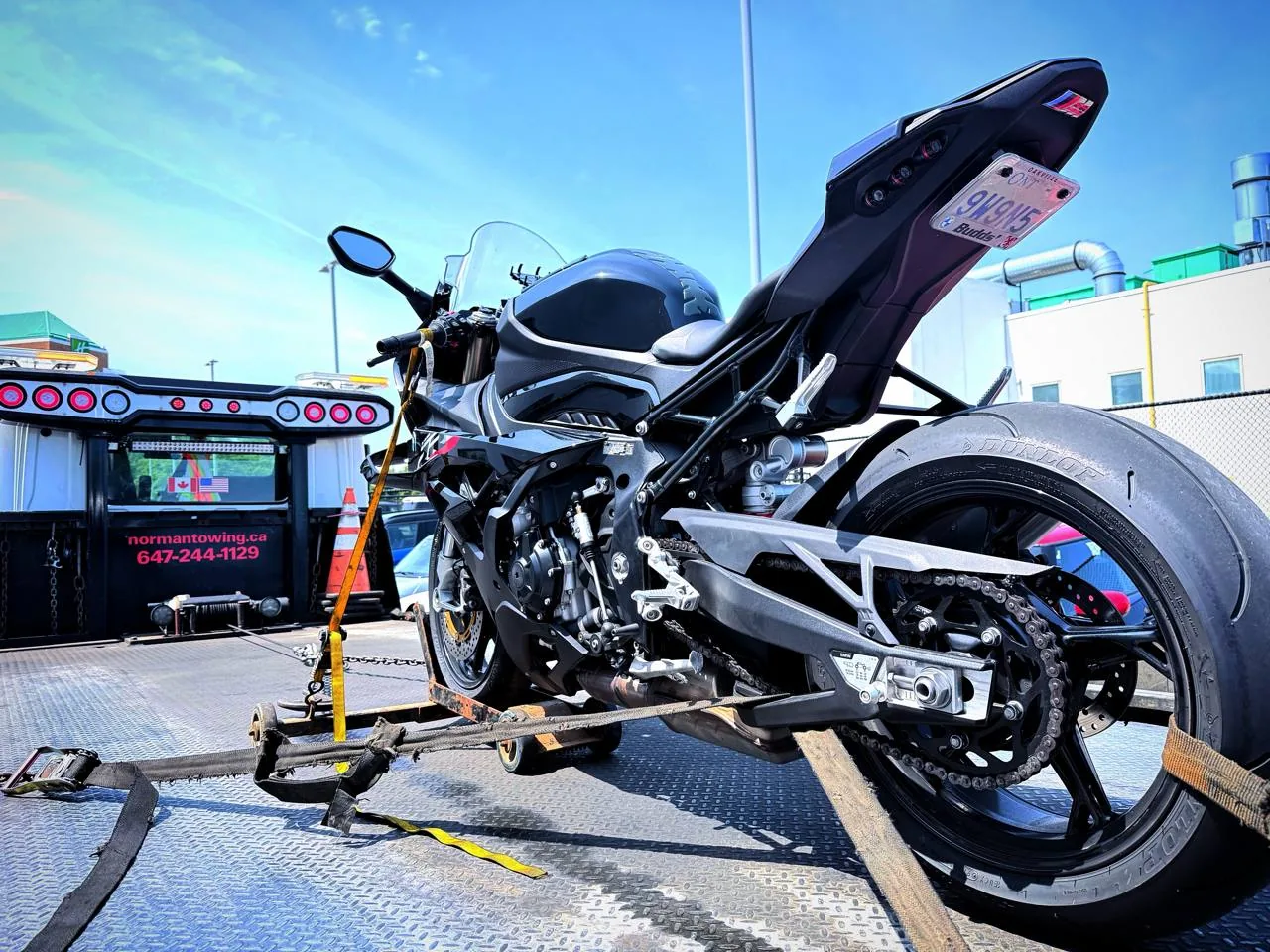Norman Towing transporting a sport motorcycle on a tow truck in Toronto