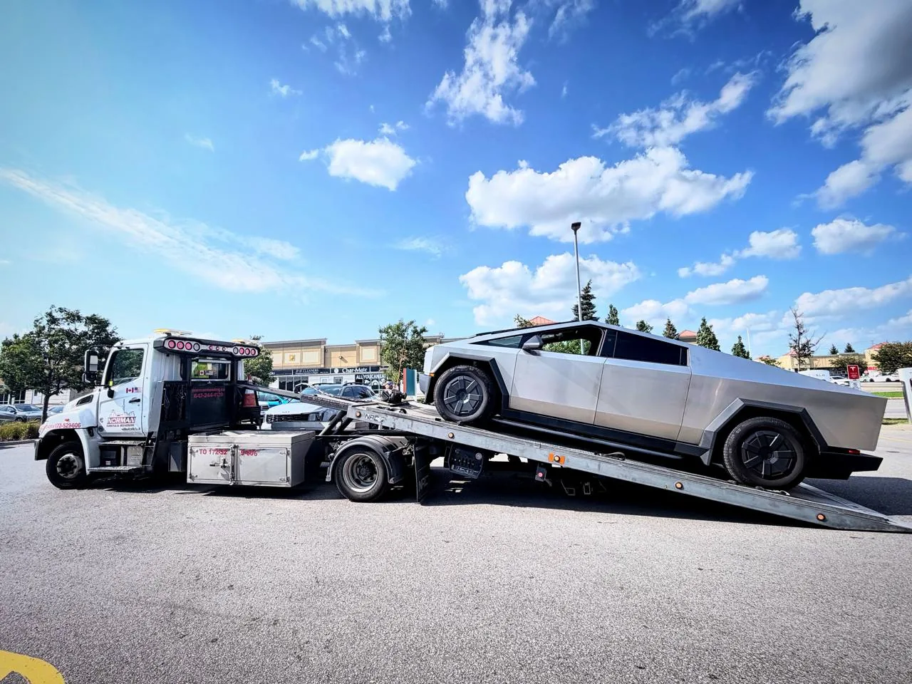 Tesla Cybertruck on a Norman Towing flatbed truck.