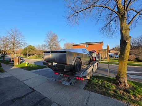 Norman Towing transporting a Tesla Cybertruck — we tow all vehicle types including EVs across the GTA. | normantowing.ca