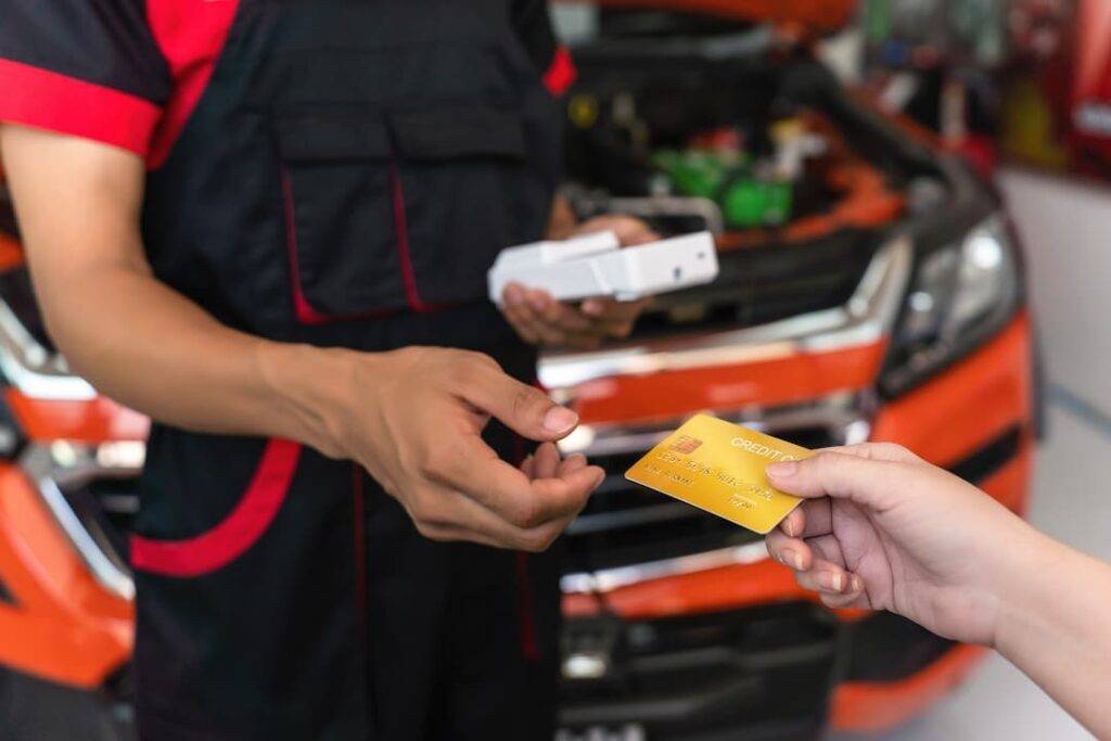 Paying a mechanic for car repairs
