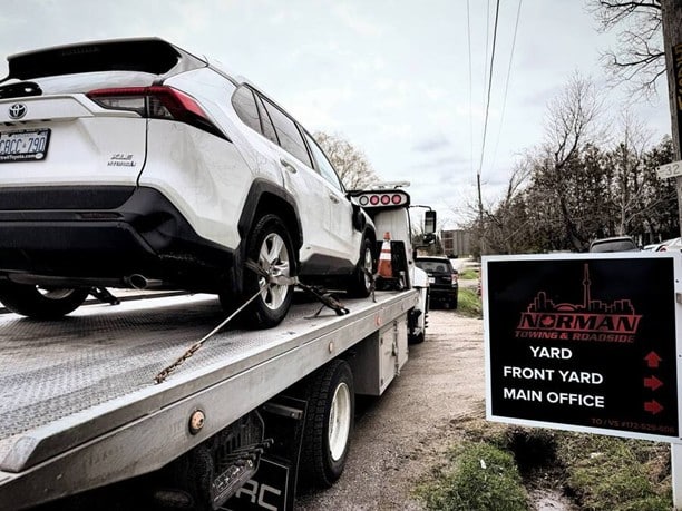 Norman Towing flatbed loading a Toyota RAV4 — 24/7 towing service across the GTA and Southern Ontario. | normantowing.ca