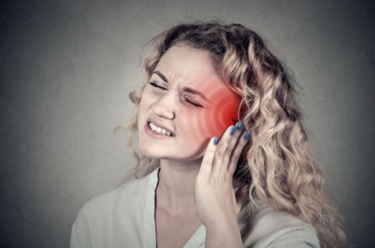 woman suffering from tinnitus