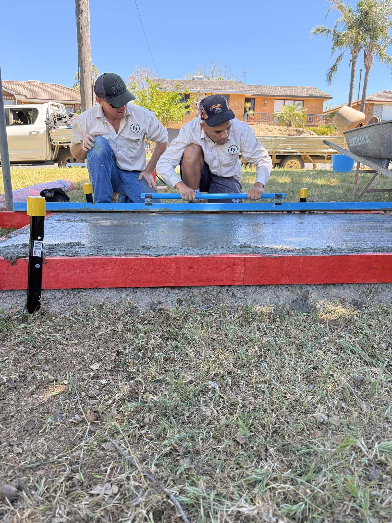 Fresh footprints participants learn how to level concrete on a footpath