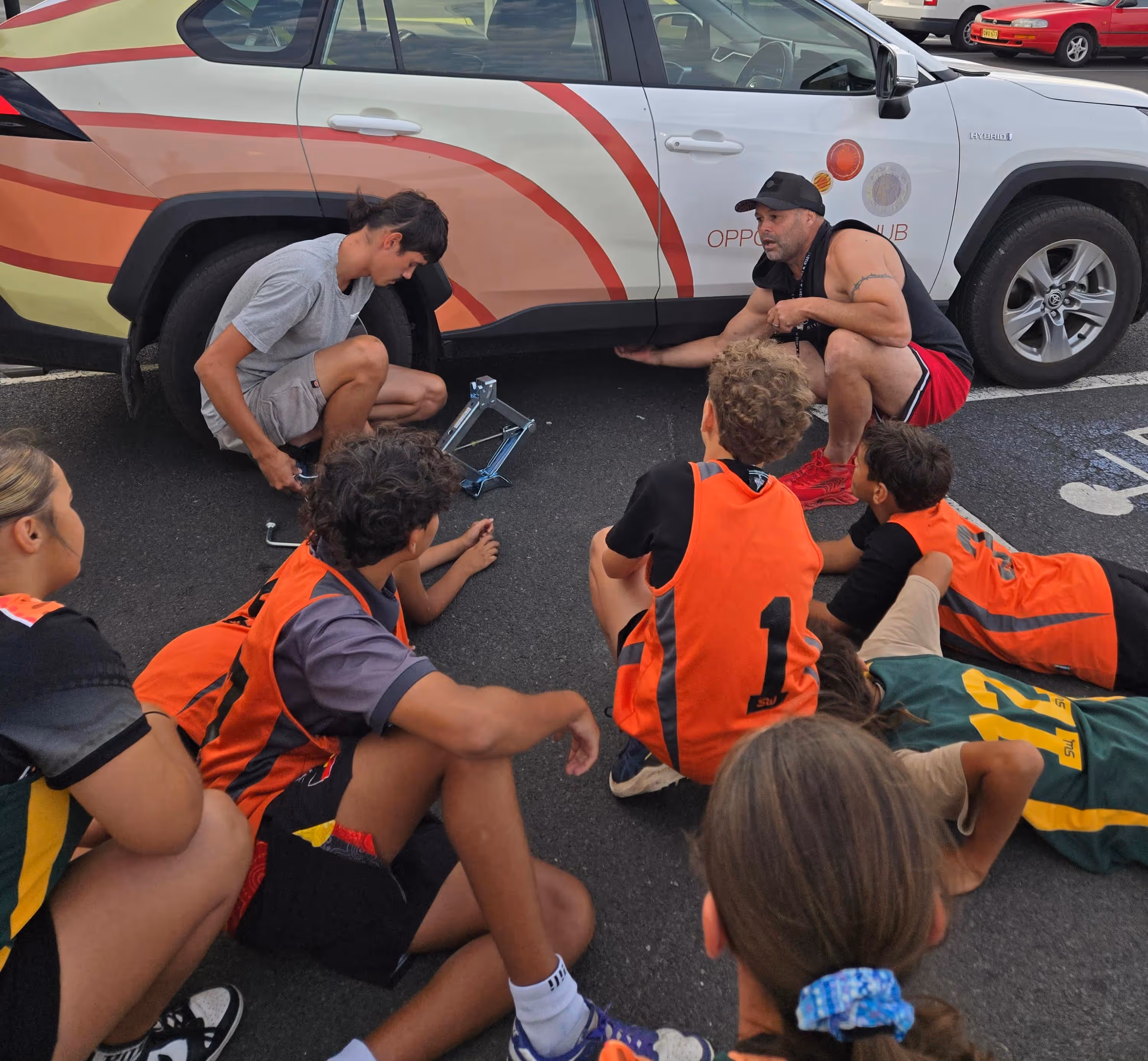 Bounce back participants learning how to change a tyre.