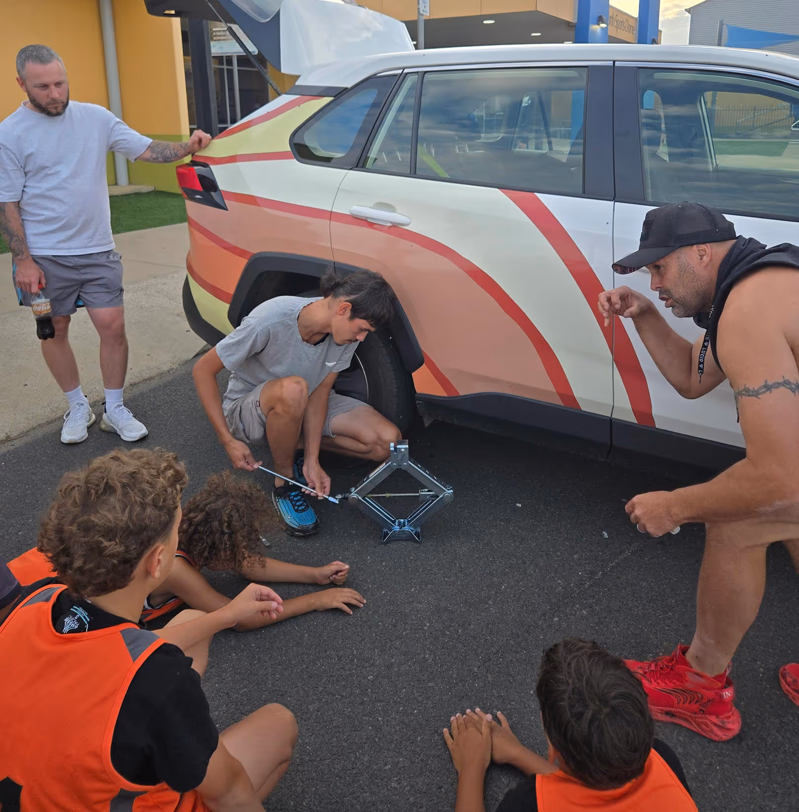 Bounce back participants learning how to change a tyre.