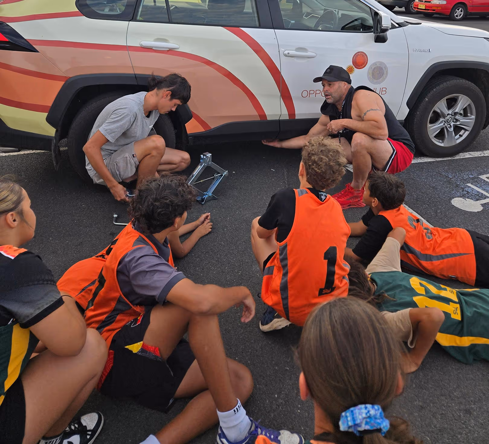 Bounce back participants learning how to change a tyre.