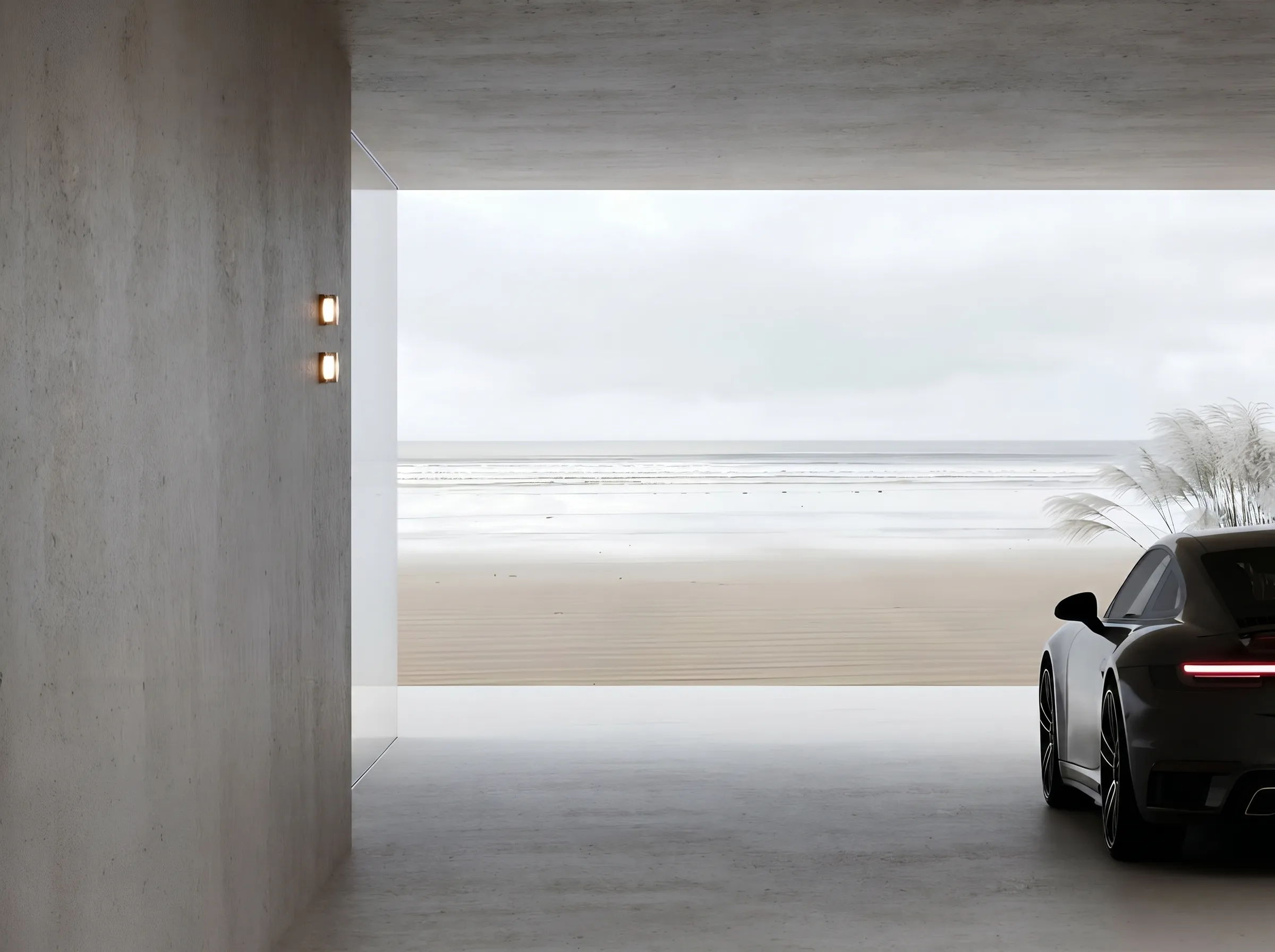 Modern concrete garage with a sports car parked, overlooking a calm beach and cloudy sky.