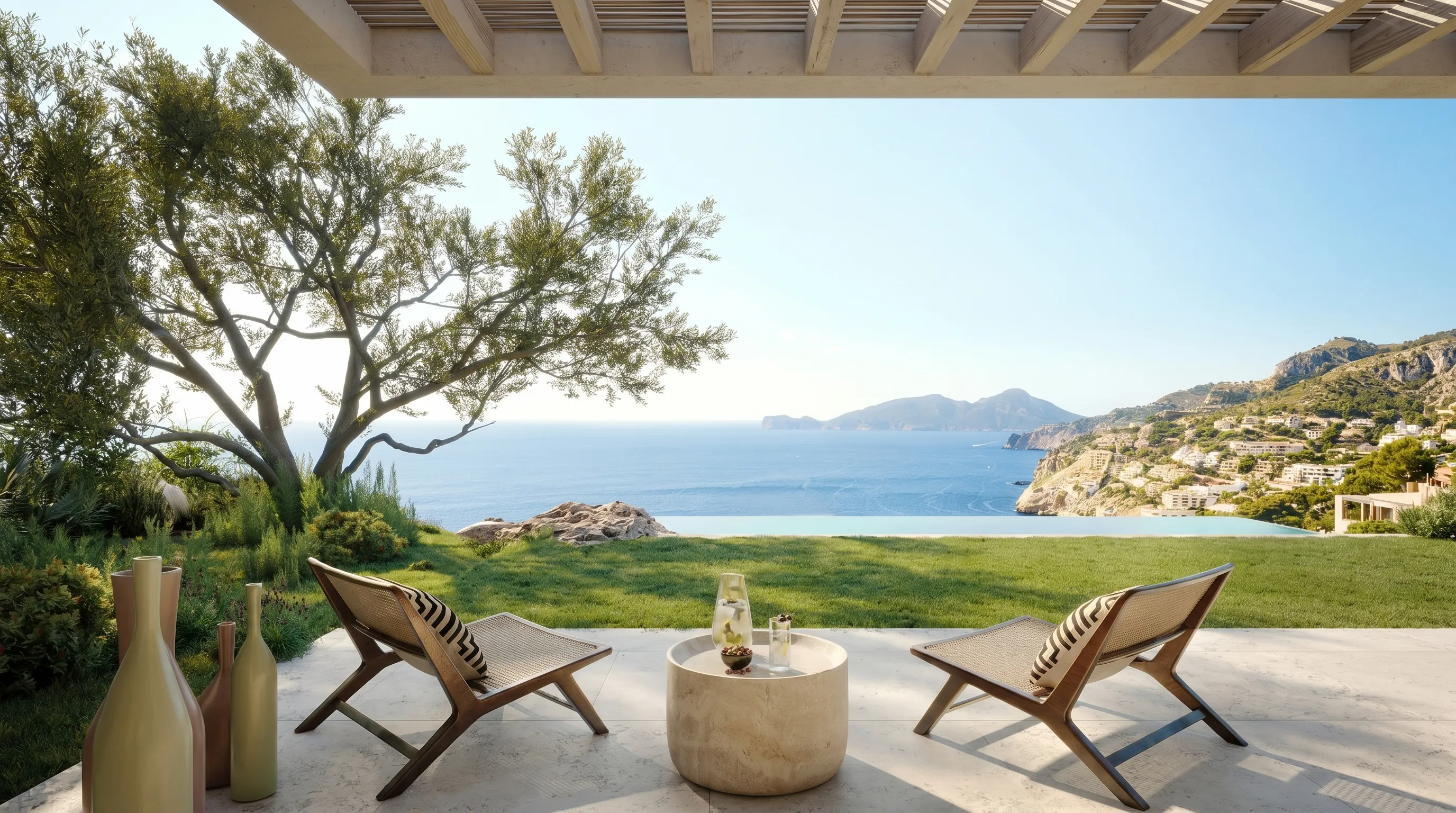 Two wooden lounge chairs with cushions face an infinity pool and sea with mountains in the background.