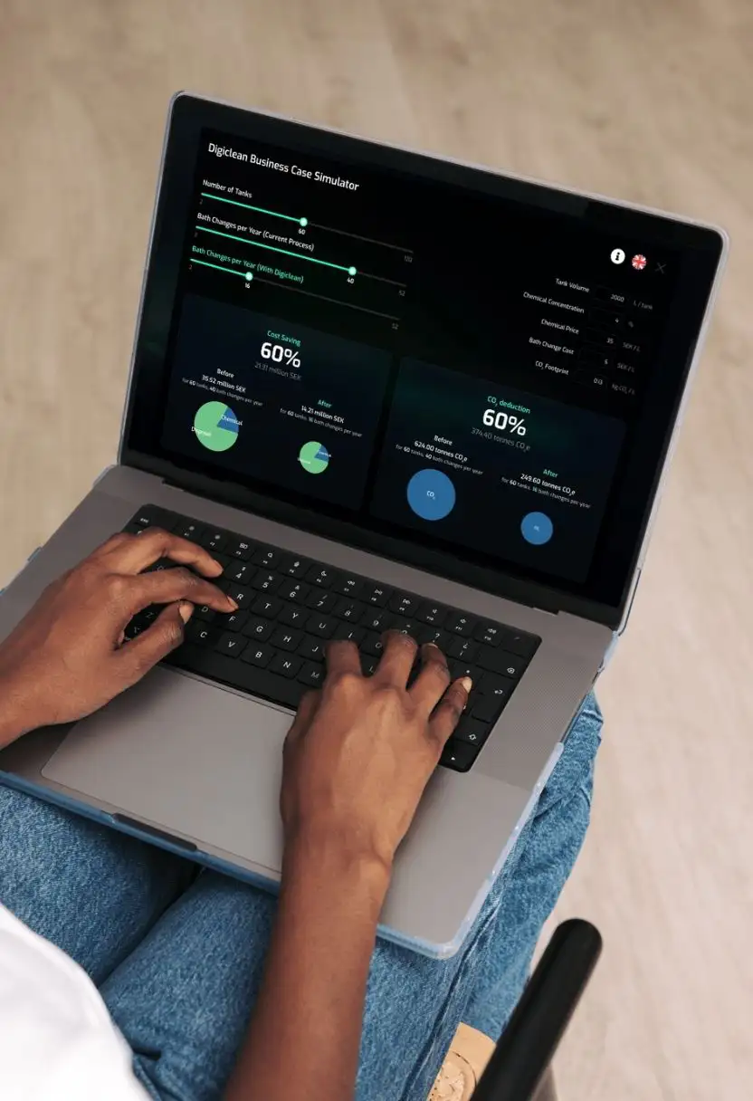 Hands typing on laptop showing a business case simulator with cost saving and CO2 reduction stats.