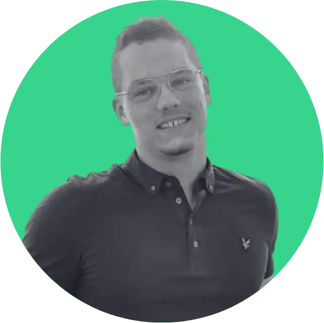Smiling man wearing glasses and a dark polo shirt against a green circular background.
