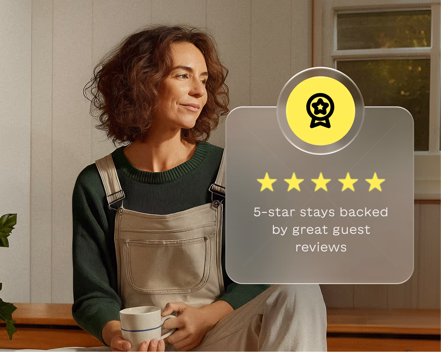 Smiling woman holding a mug sitting indoors next to a graphic showing five yellow stars and the text '5-star stays backed by great guest reviews'.