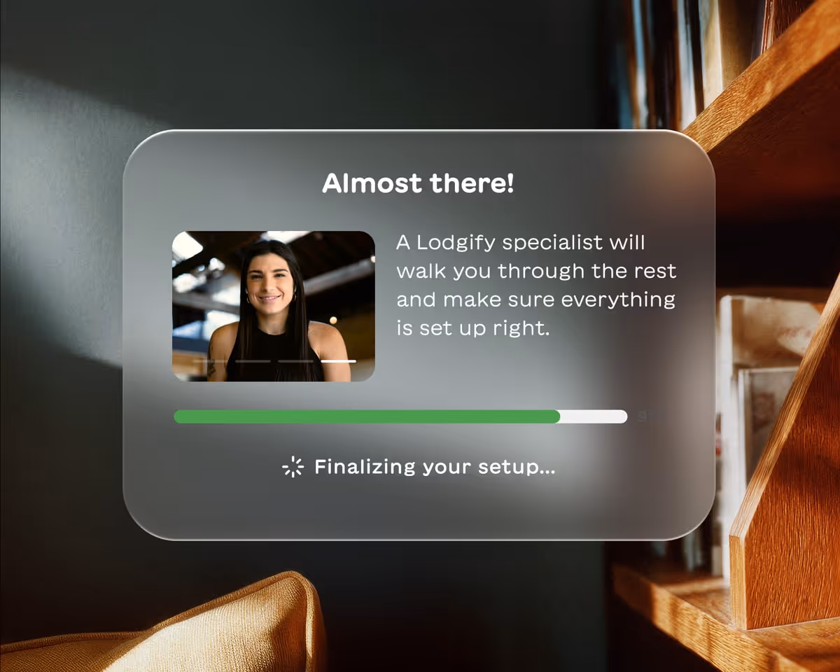 Popup window showing a smiling woman with text saying a Lodgify specialist will help complete the setup, with a progress bar nearly finished.