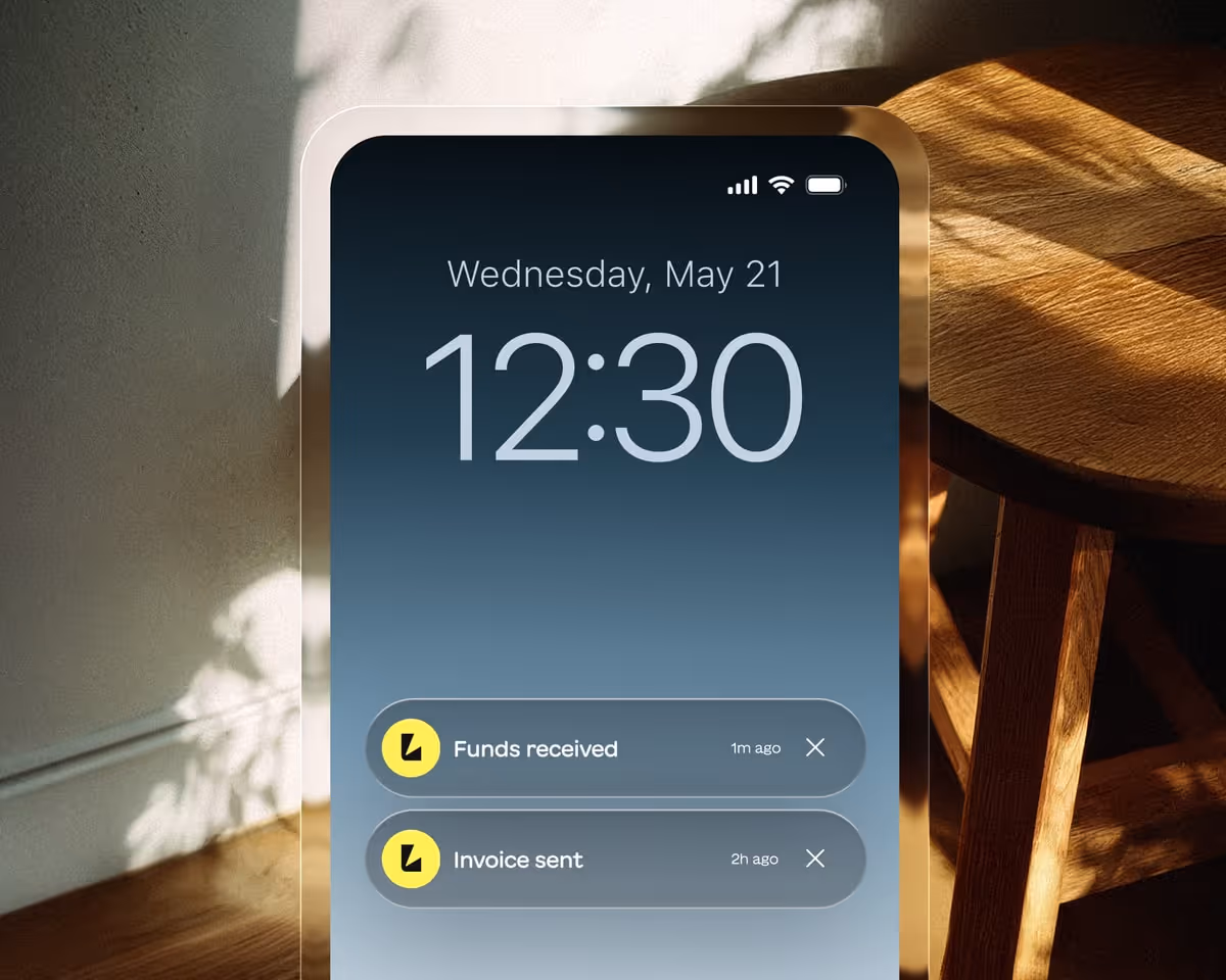 Smartphone lock screen showing date Wednesday, May 21 at 12:30 with notifications for 'Funds received' and 'Invoice sent'.