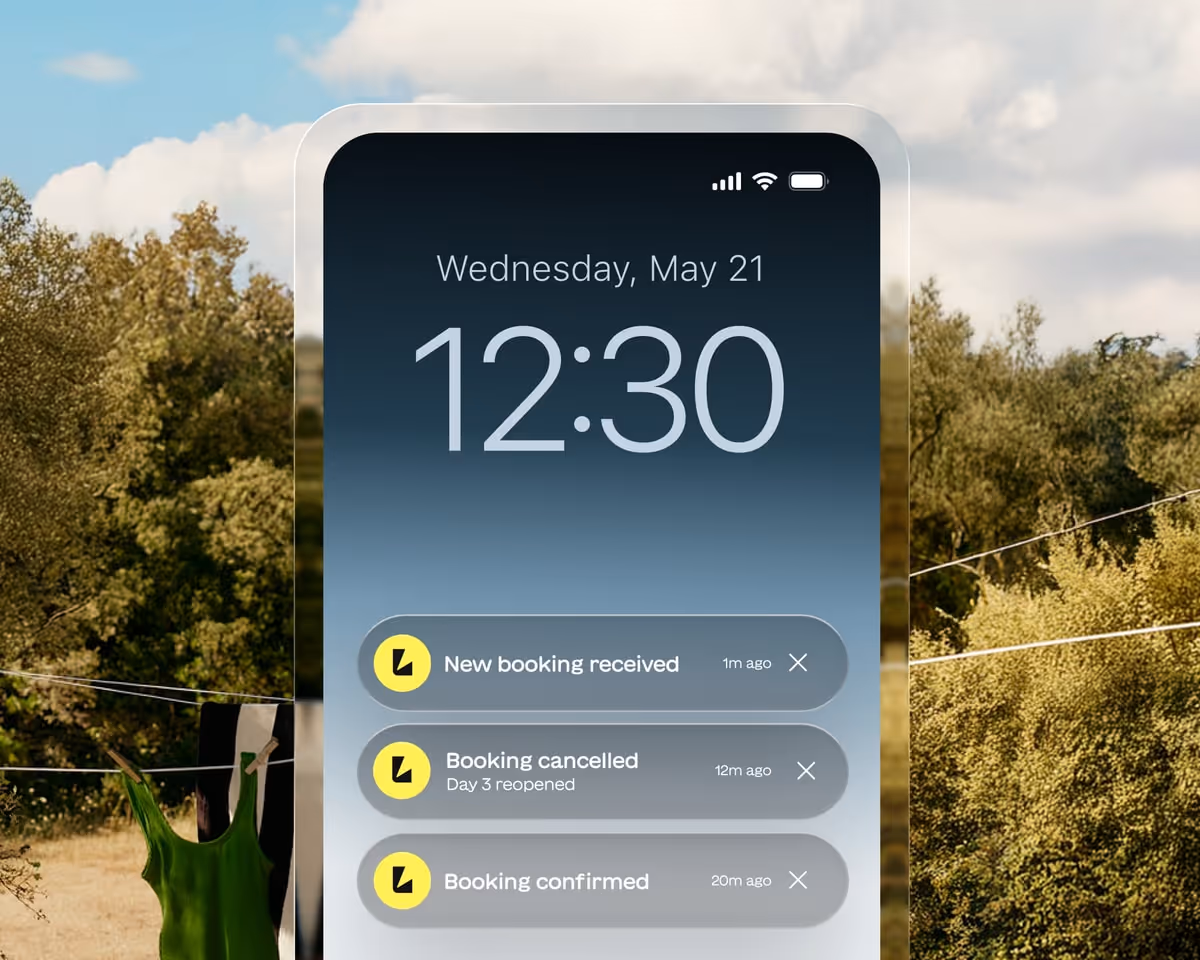 Smartphone lock screen displaying the time 12:30, date Wednesday May 21, and three booking notifications for new booking received, booking cancelled, and booking confirmed.