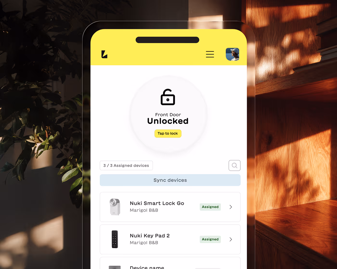 Smartphone screen displaying a smart home app showing front door unlocked status with options to sync and manage Nuki smart lock devices.