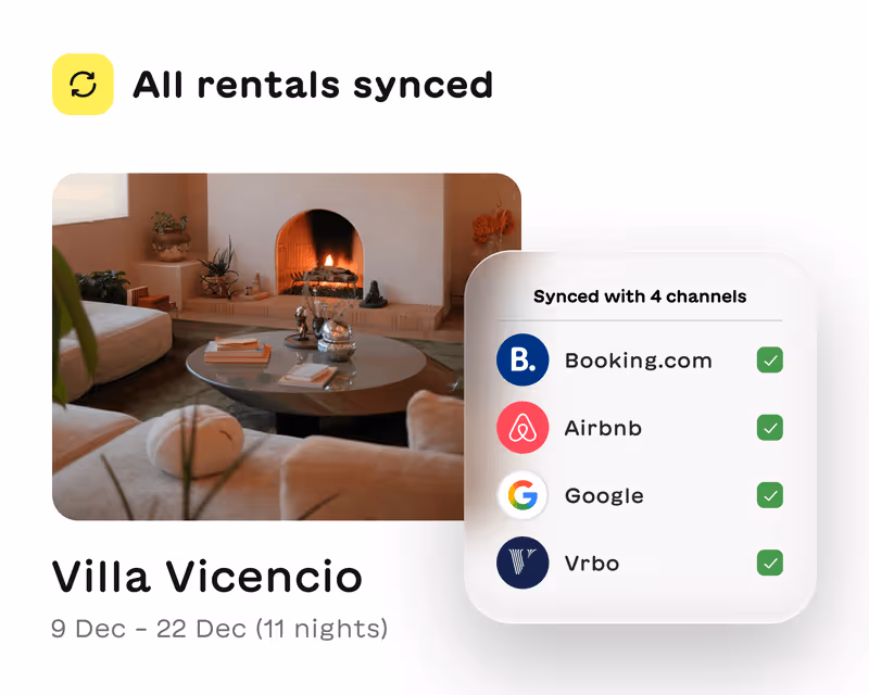 Cozy living room with a lit fireplace and round coffee table, showing Villa Vicencio rental synced with Booking.com, Airbnb, Google, and Vrbo.