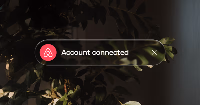 Notification bar with Airbnb logo and text 'Account connected' over a dark leafy background.