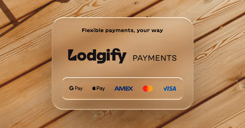 Lodgify Payments card showcasing flexible payment options including Google Pay, Apple Pay, AMEX, Mastercard, and Visa on a wooden surface background.
