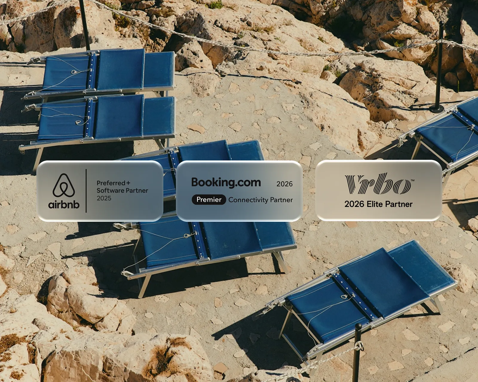 Outdoor stone patio with blue lounge chairs and overlaid logos of Airbnb, Booking.com, and Vrbo indicating partnership status for 2025 and 2026.
