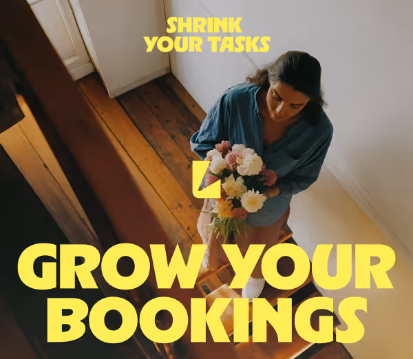 Woman holding a bouquet of flowers standing on wooden stairs, with overlay text 'Shrink Your Tasks' and 'Grow Your Bookings' in yellow.