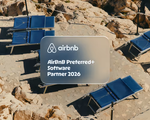 Blue lounge chairs on rocky beach with Airbnb Preferred+ Software Partner 2026 text overlay.