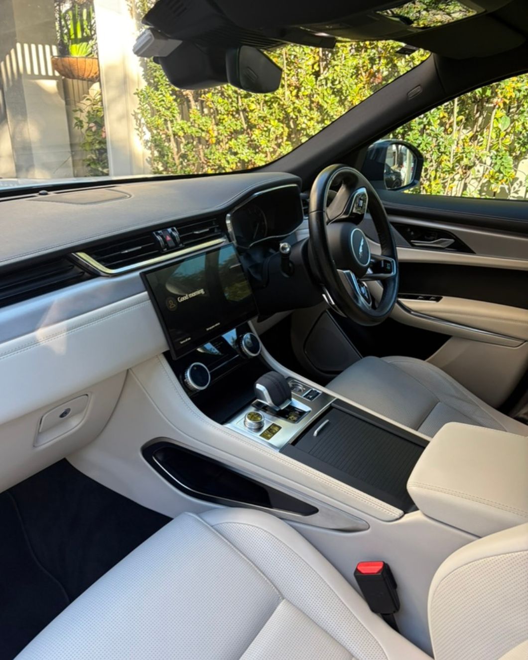 Detailed luxury car interior — white leather Jaguar cabin