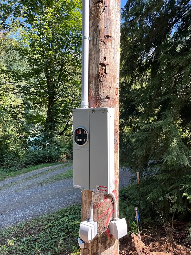 Outdoor electrical control box installed in a wooden post in Arlington